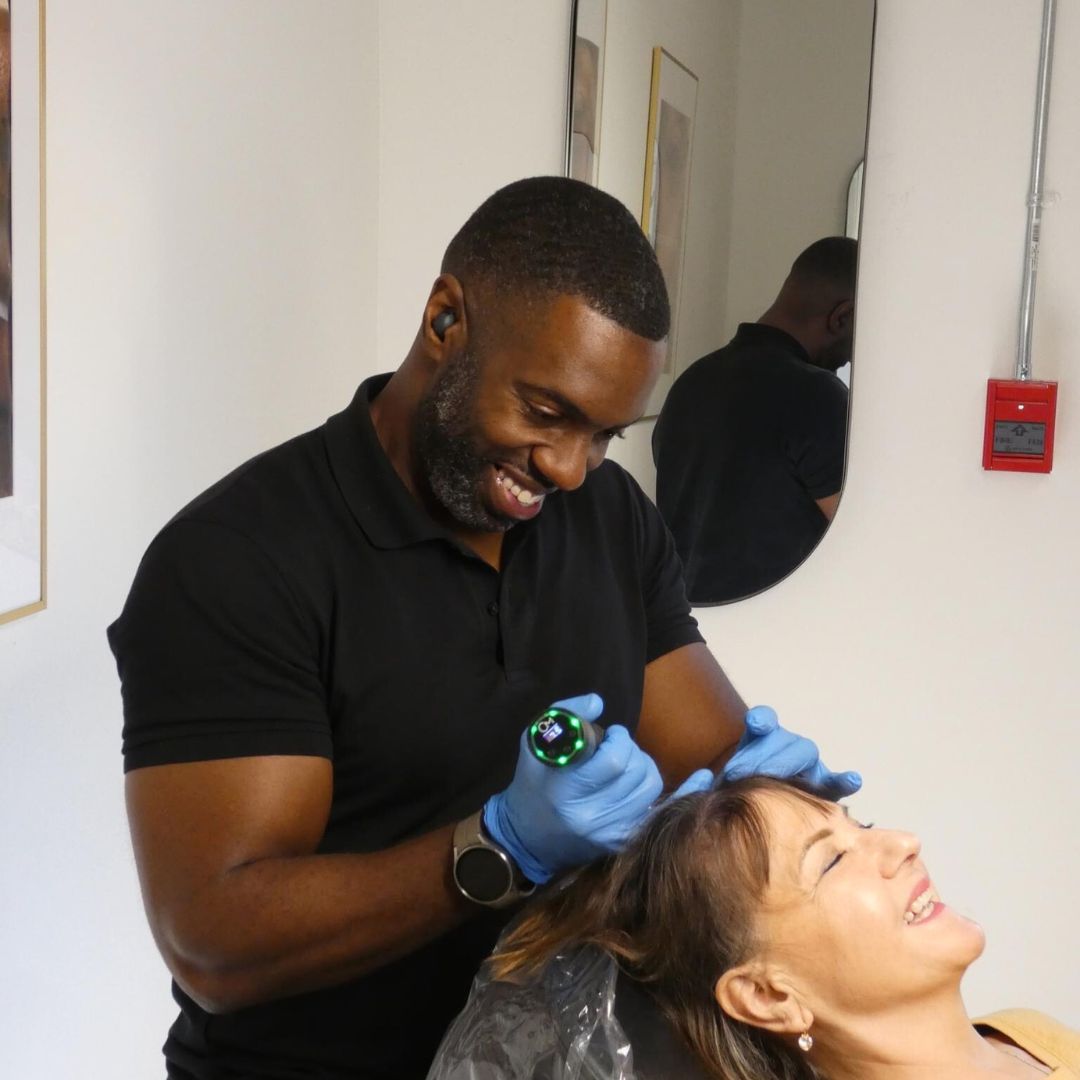 Paramedical tattoo specialist performing scalp micropigmentation tattoo treatment on a woman with long hair at SKN Deep clinic in Grimsby, Niagara.
