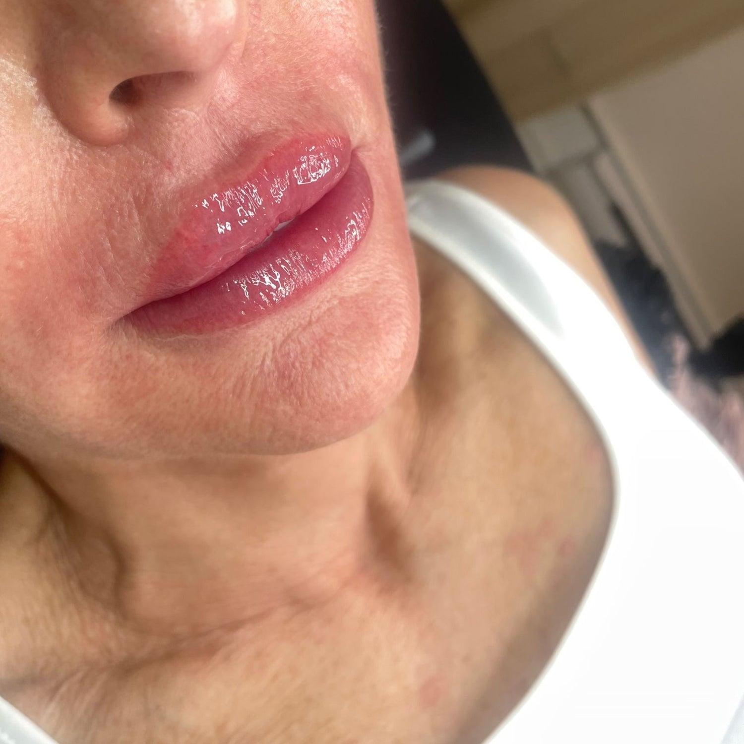 Soft pink permanent lip blush on mature lips at SKN Deep cosmetic tattoo clinic in Grimsby, showing natural, glossy results after lip colour tattoo treatment.