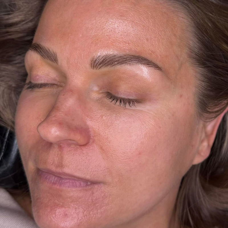 Close-up of a woman with closed eyes and a neutral expression after getting nano brows done in Grimsby clinic.
