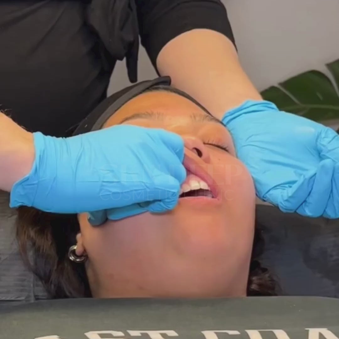 Woman receiving buccal facial massage with intraoral technique for jaw tension relief at SKN Deep Cosmetic Clinic.